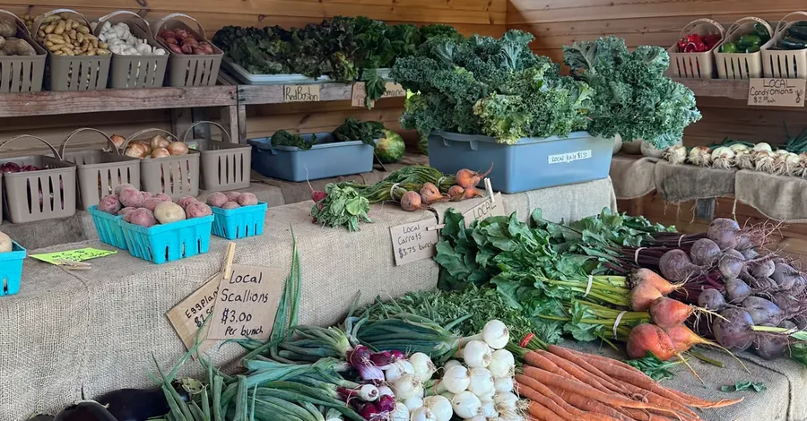A farm market stand filled with fresh seasonal produce